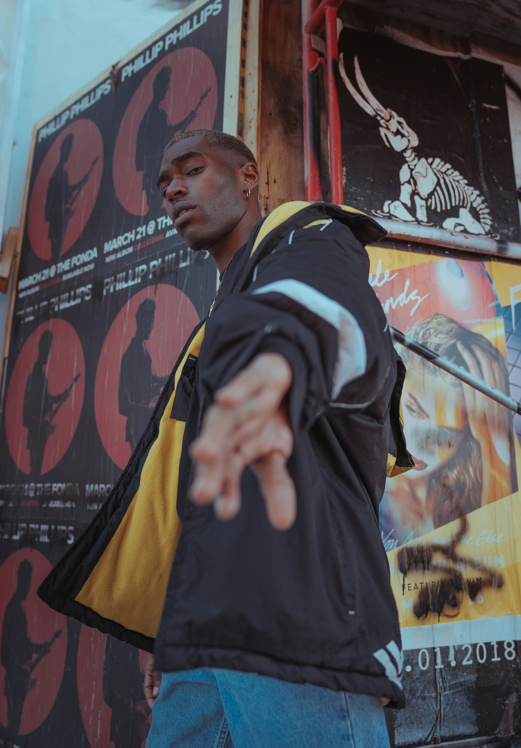A person of influence in front of cultural posters